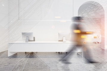 Businessman walking in spacious white office