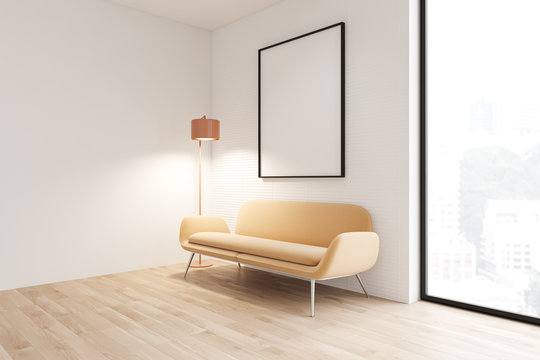White living room with yellow sofa and poster