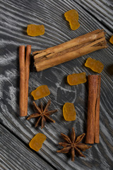 Jelly chewing sweets. Cinnamon sticks and anise stars. Scattered on brushed pine boards painted in black and white.