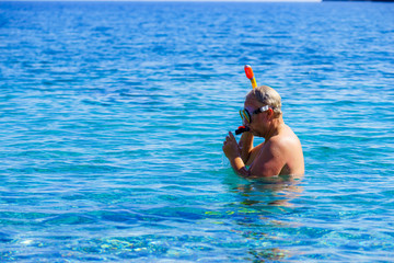 Man with snorkeling tube in sea