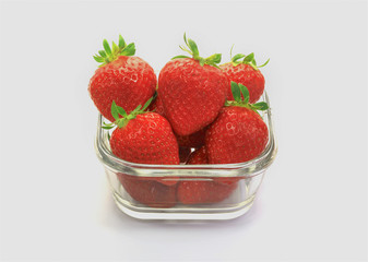 strawberries in a bowl isolated on white background