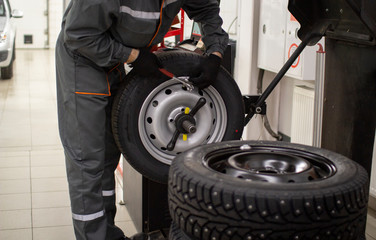 Tire service.Balancing the wheels of the car in the workshop.