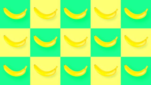 Looping abstract video with rotating bananas on a yellow-green background with squares and cells.