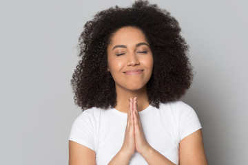 Mindful hopeful african american millennial woman praying, asking for help.