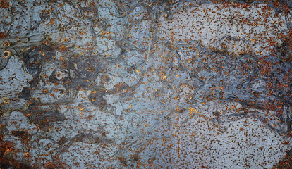 The texture is metallic. Industrial background from an old rusty metal. Textured metal background with rust and cracks.