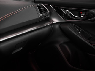 Naklejka na ściany i meble Close up door and panel black interior of modern car with red stitching