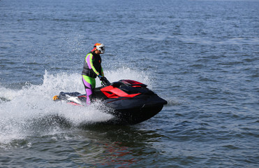 The young man quickly goes by water scooter