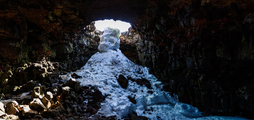 Arctic cave with snow pouring down