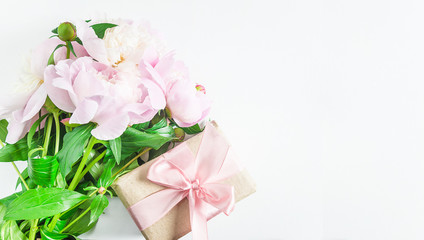 Romantic greeting card with handmade gift box and bunch of pink peonies. White background, space for text