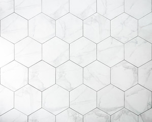 Tiles. A white marble wall with hexagon tiles for texture and background. - obrazy, fototapety, plakaty