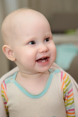 Smiling little child with four teeth erupted