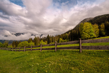 Fototapeta na wymiar mountain landscape with green field and blue sky
