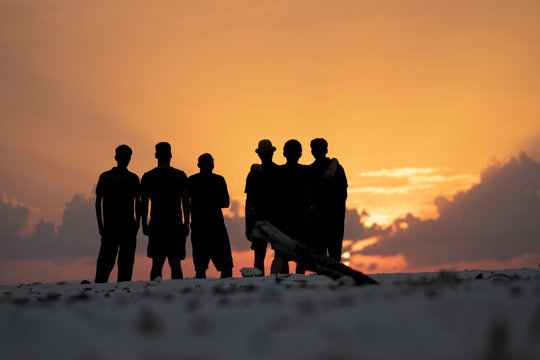 Silhouette Of Group Of Six People In A Beach During Sunset And Golden Hour, Leisure Lifestyle