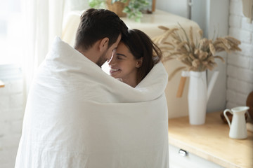 Happy married family couple enjoying sweet tender morning moment.