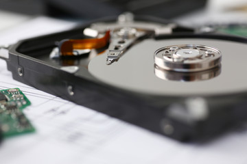 Hard drive from computer or laptop lies on the table in the repair shop. Performs fault diagnostics...
