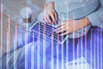 Forex graph with businessman working on computer in office on background. Concept of analysis....