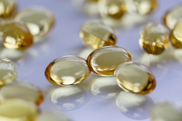 Tablets scattered yellow fish oil on table of the pharmaceutical laboratory pill for the prescription and treatment of various diseases chemistry