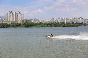 Fototapeta premium The man is enjoying the scooter at hanriver south korea;