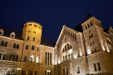 Fototapeta na wymiar Neo-Romanesque Imperial castle with towers at night in Poznan.