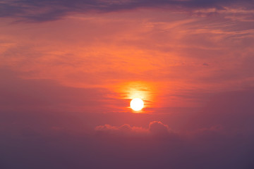 Full circle sun on a red orange sky.