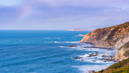 Fototapeta na wymiar View of the dramatic Pacific Ocean coastline, with rocky cliffs, on a sunny day, Point Reyes National Seashore, California