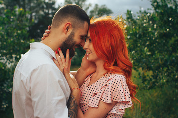 Naklejka premium happy, couple in love cuddling, Redhead girl. minute to kiss. date