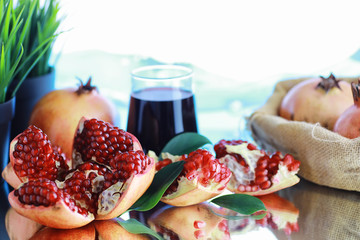 Ripe grains of pomegranate on the table. Pomegranate juice.