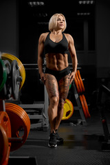Female bodybuilder posing in gym.