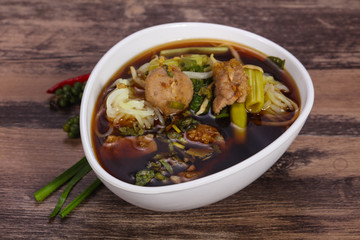 Thai style soup with meat and mushrooms