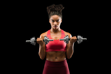 Athletic afro girl having work out with barbells