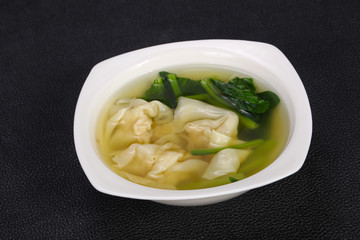 Asian traditional Wonton soup with herbs
