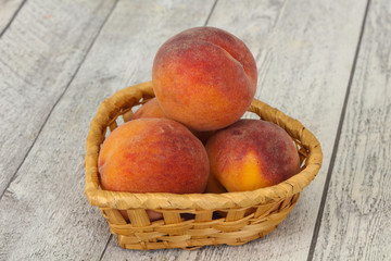 Peach heap in the wooden basket