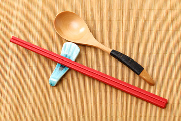 wooden spoon and chopsticks in hay background