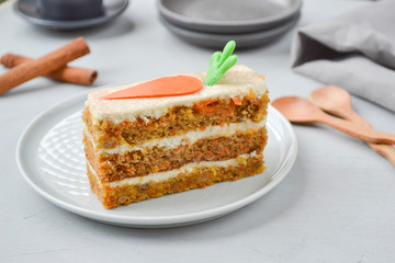 Carrot cake for mother's Day.  Layer cake with grated carrots, walnuts and dried apricots, topped with cream cheese and frosting. A delightful pleasure to relax. Close-up, copyspace, top view.