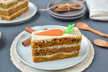 Carrot cake for mother's Day.  Layer cake with grated carrots, walnuts and dried apricots, topped with cream cheese and frosting. A delightful pleasure to relax.  Close-up, copyspace, top view.