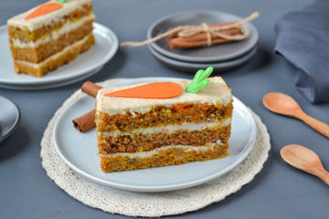 Carrot cake for mother's Day.  Layer cake with grated carrots, walnuts and dried apricots, topped with cream cheese and frosting. A delightful pleasure to relax.  Close-up, copyspace, top view.