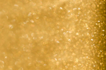 Gold background light. Golden glitter texture.