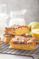 Homemade blondie (blonde) brownies apple cake square slices with glass of milk