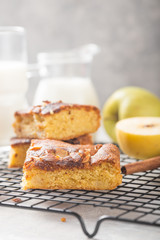 Homemade blondie (blonde) brownies apple cake square slices with glass of milk