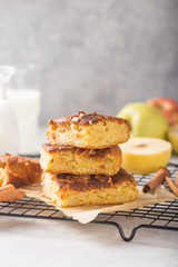 Homemade blondie (blonde) brownies apple cake square slices with glass of milk