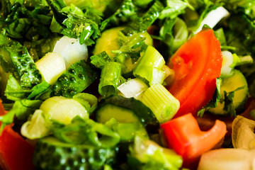 Fresh salad with tomatoes, lettuce, onion, cucumbers and parsley.