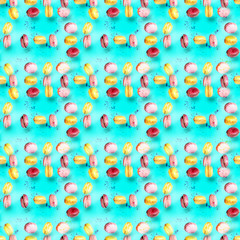 Abstract seamless pattern with flying colored macaroons, holiday concept.