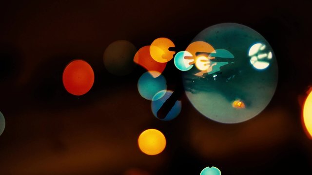 Colorful octagons blink on dark background. Multicolored defocused lights blinking. - Powered by Adobe