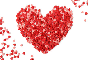 heart shape made from candy hundreds and thousands sprinkles on a white background
