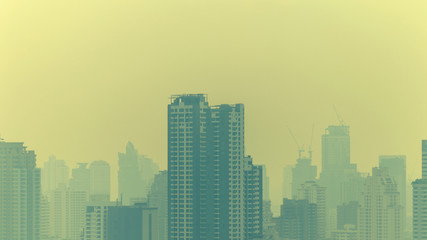 Fototapeta na wymiar cityscape of high rise buildings in poor weather morning, haze of pollution covers city, global warming concept