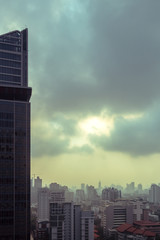 Fototapeta na wymiar cityscape of high rise buildings in poor weather morning, haze of pollution covers city, global warming concept