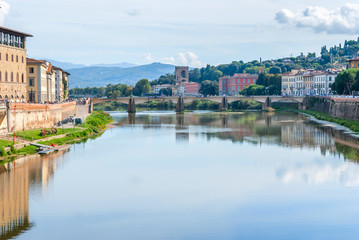 View of stone bridge over Arno river in Florence, Tuscany, Italy.