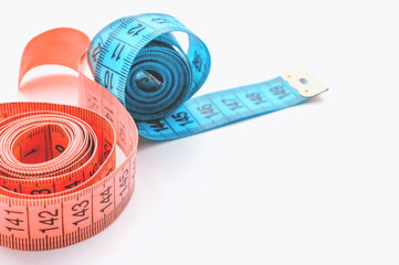 centimeter ribbon pink and blue on a white background. The concept of weight loss and a healthy...
