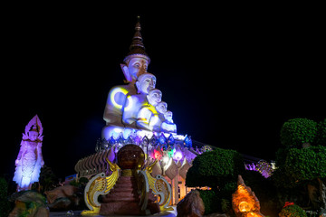 Five big buddhas statue with colorful illuminate in the night at Wat Prathat Phasornkaew, The unique temple in Khao Kho, Thailand.