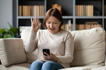 Happy senior woman have video call on smartphone